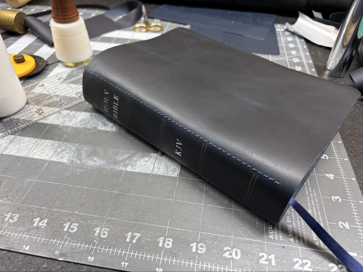 Dark navy leather Bible with blue edge stitching